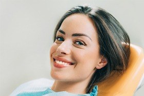 A young woman smiling in the dentist chair