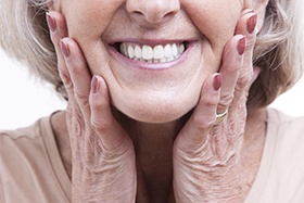 closeup of smiling older patient with dental implants in Juno Beach