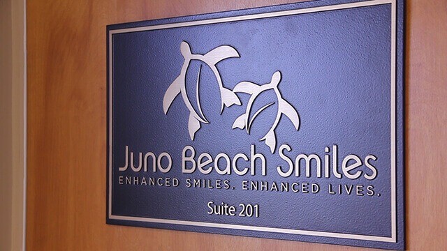 Juno Beach Smiles wall sign