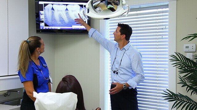 Dentist and patient in dental exam room