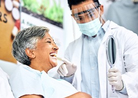 Dentist showing patient smile in mirror