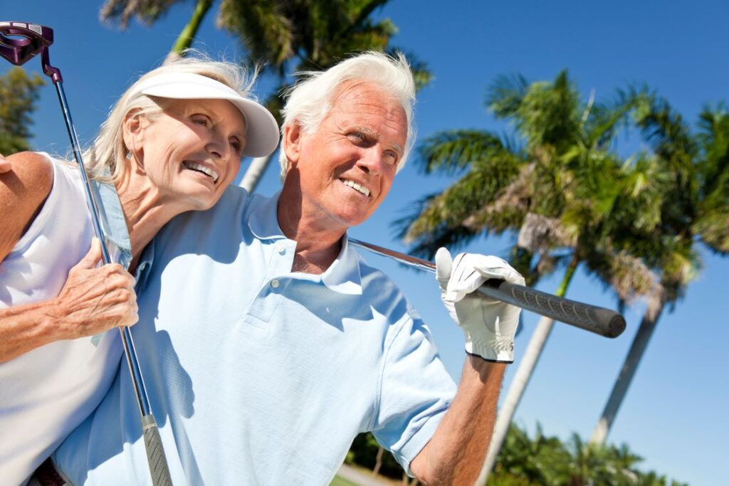 An older man and woman golfing